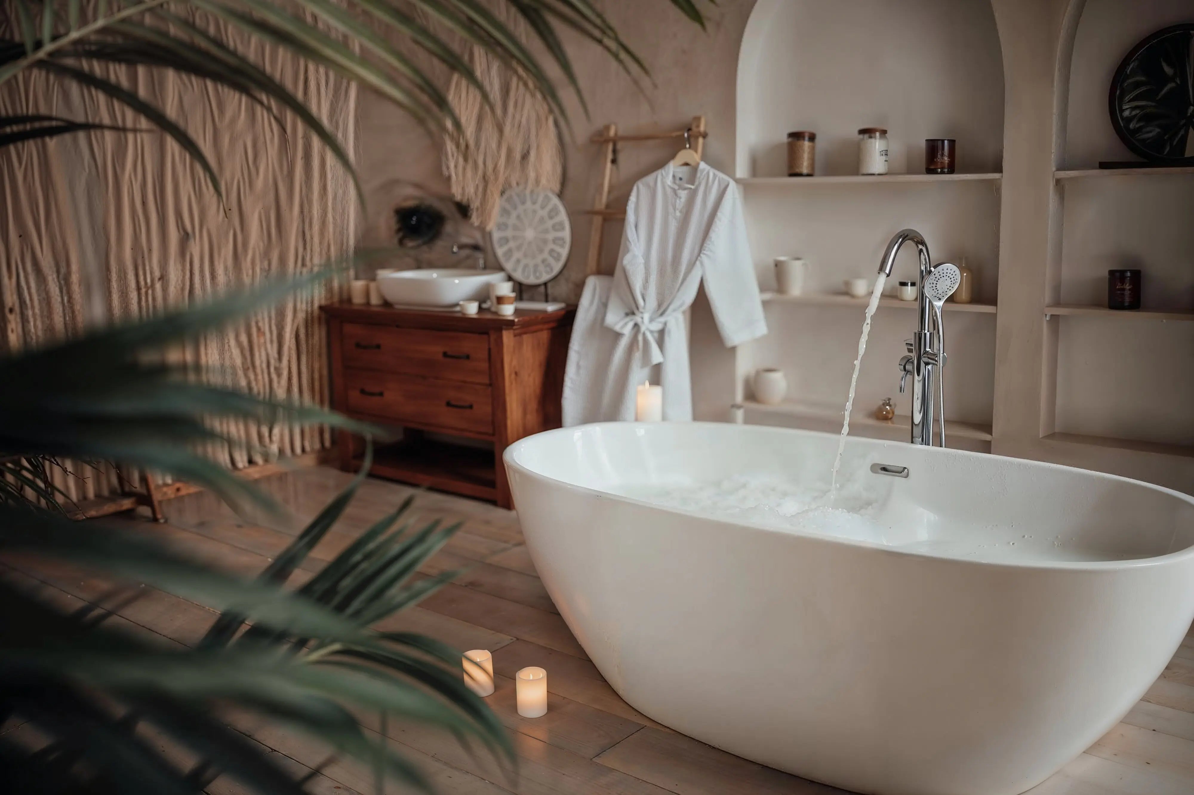 Dreamwerks bathtub in a modern bathroom set with plants and running water in the bathtub.