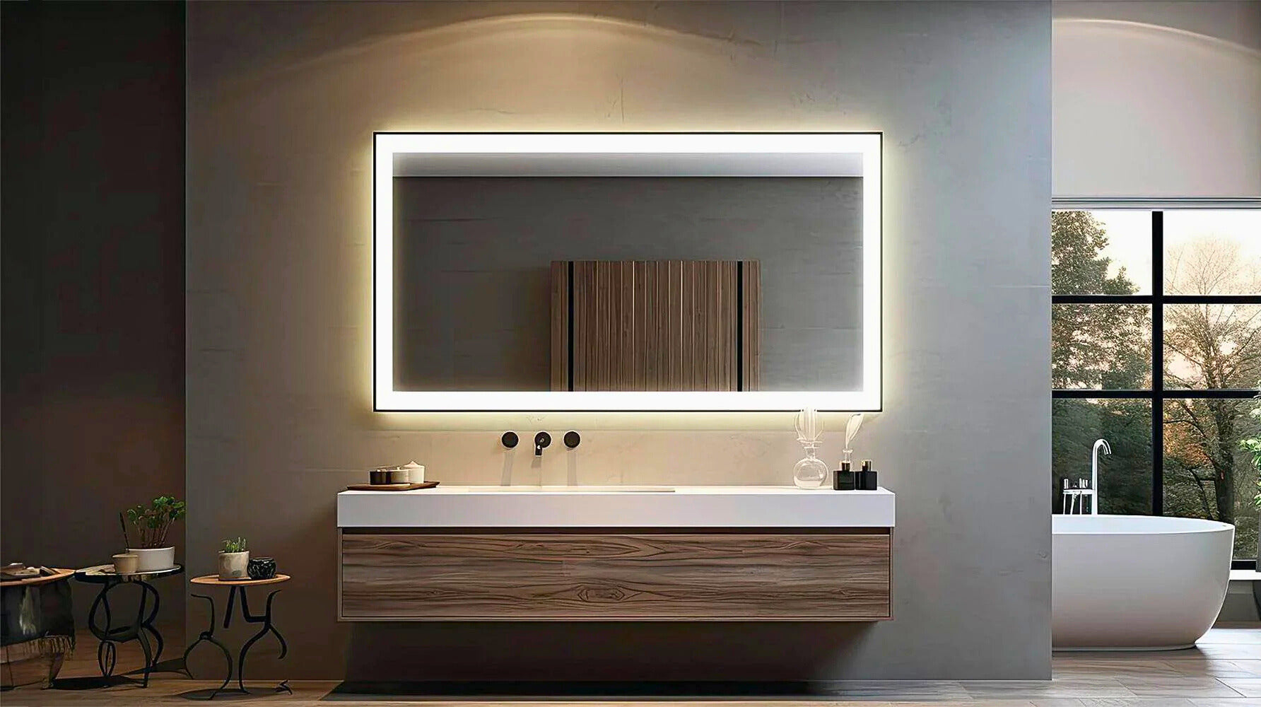 Big LED mirror in a luxury bathroom lighted up with bathtub on the side and floating white vanity.