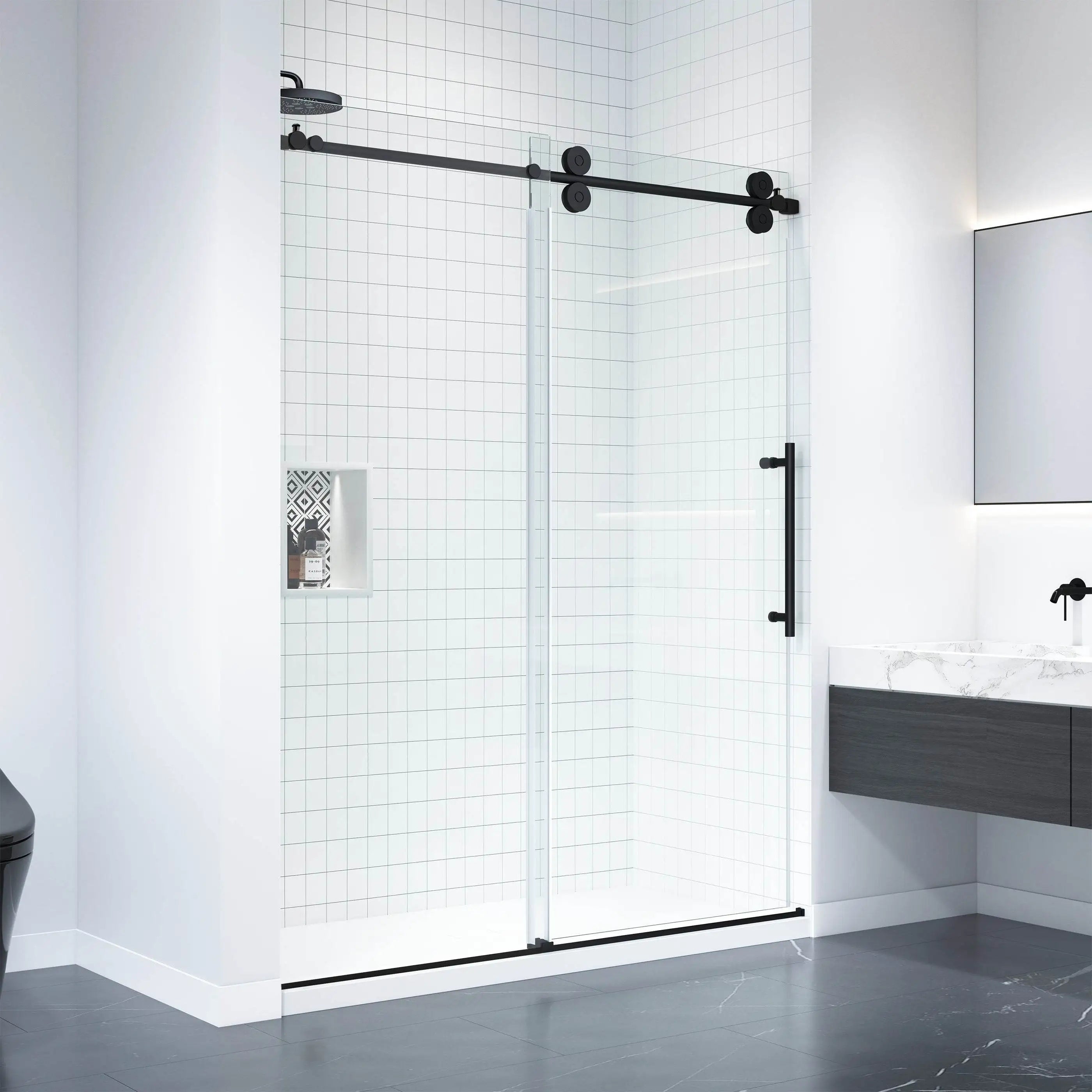 Modern bathroom featuring a clear glass Dreamwerks sliding shower door with matte black hardware and exposed roller mechanism. The shower walls are covered in white subway tiles, contrasting with dark gray floor tiles and a floating vanity.