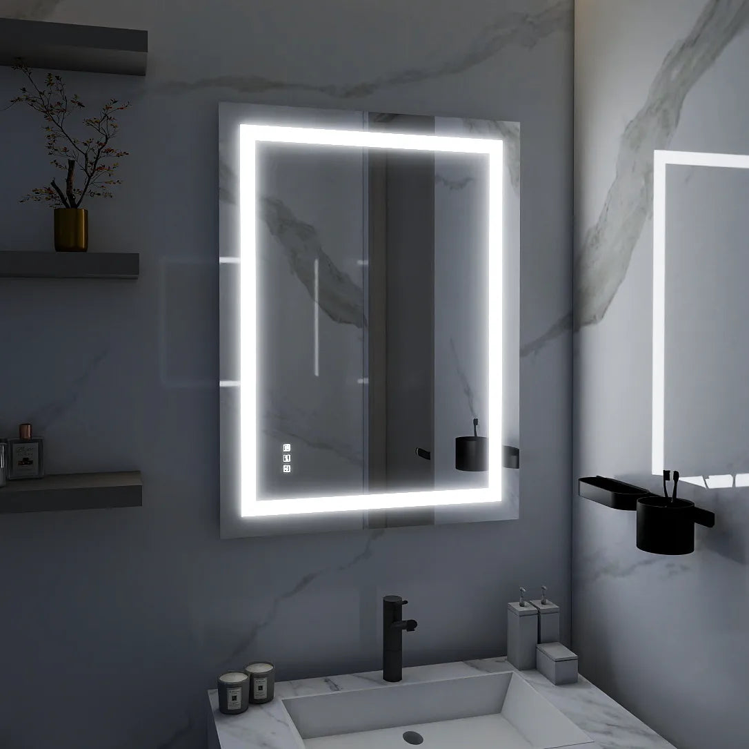 Modern LED bathroom mirror with illuminated frame and touch controls, mounted above a white vanity in a marble wall bathroom.