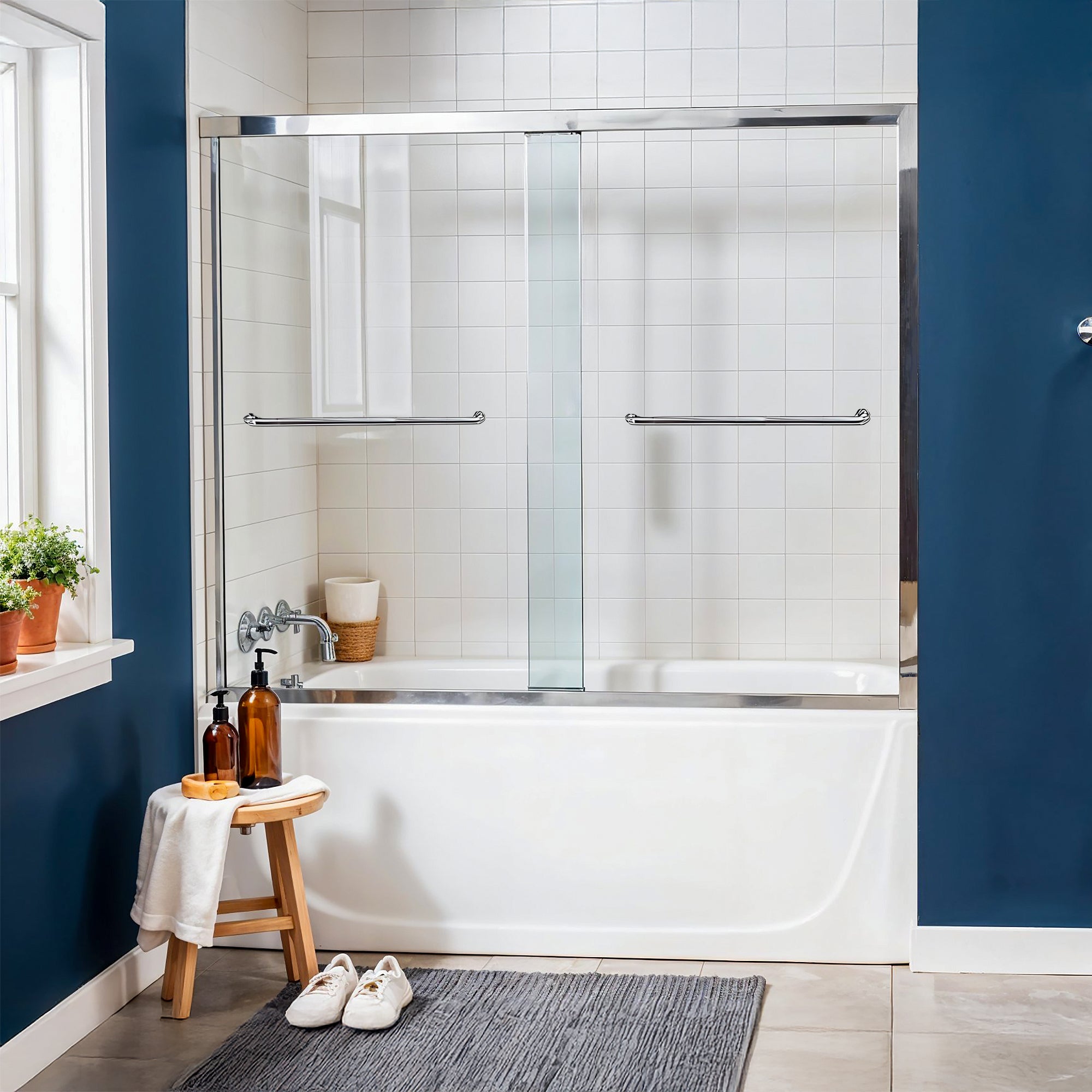 Small bathroom with bathtub and dreamwerks shower tub sliding door on top of it.