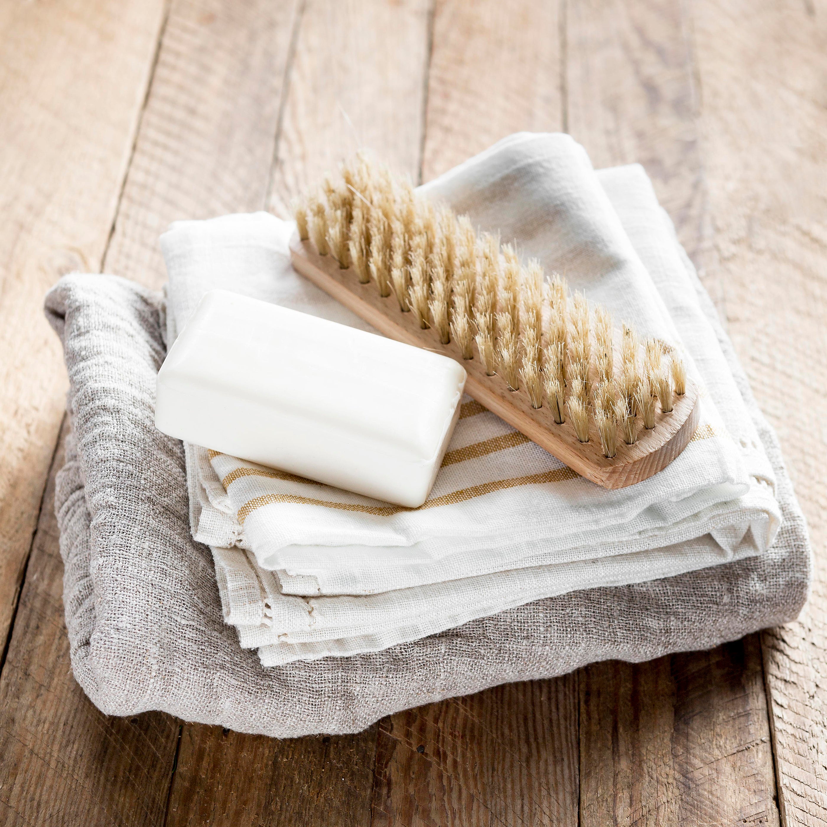 soap-towel-brush-set-together-on-bathroom-ground