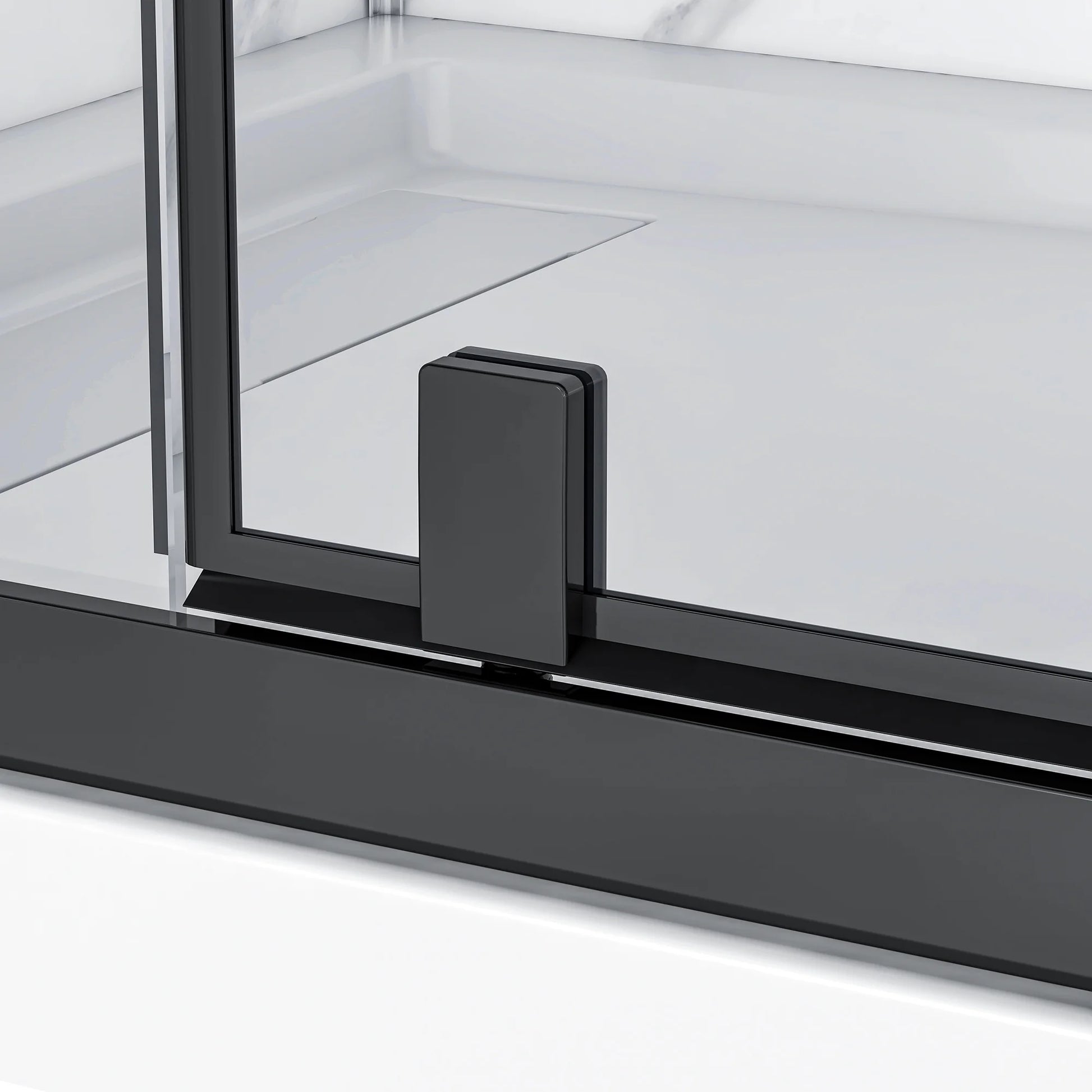 Close-up of a black corner bracket on a glass panel with a white background