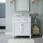 Bathroom vanity with marble countertop, sink, and decorative elements.