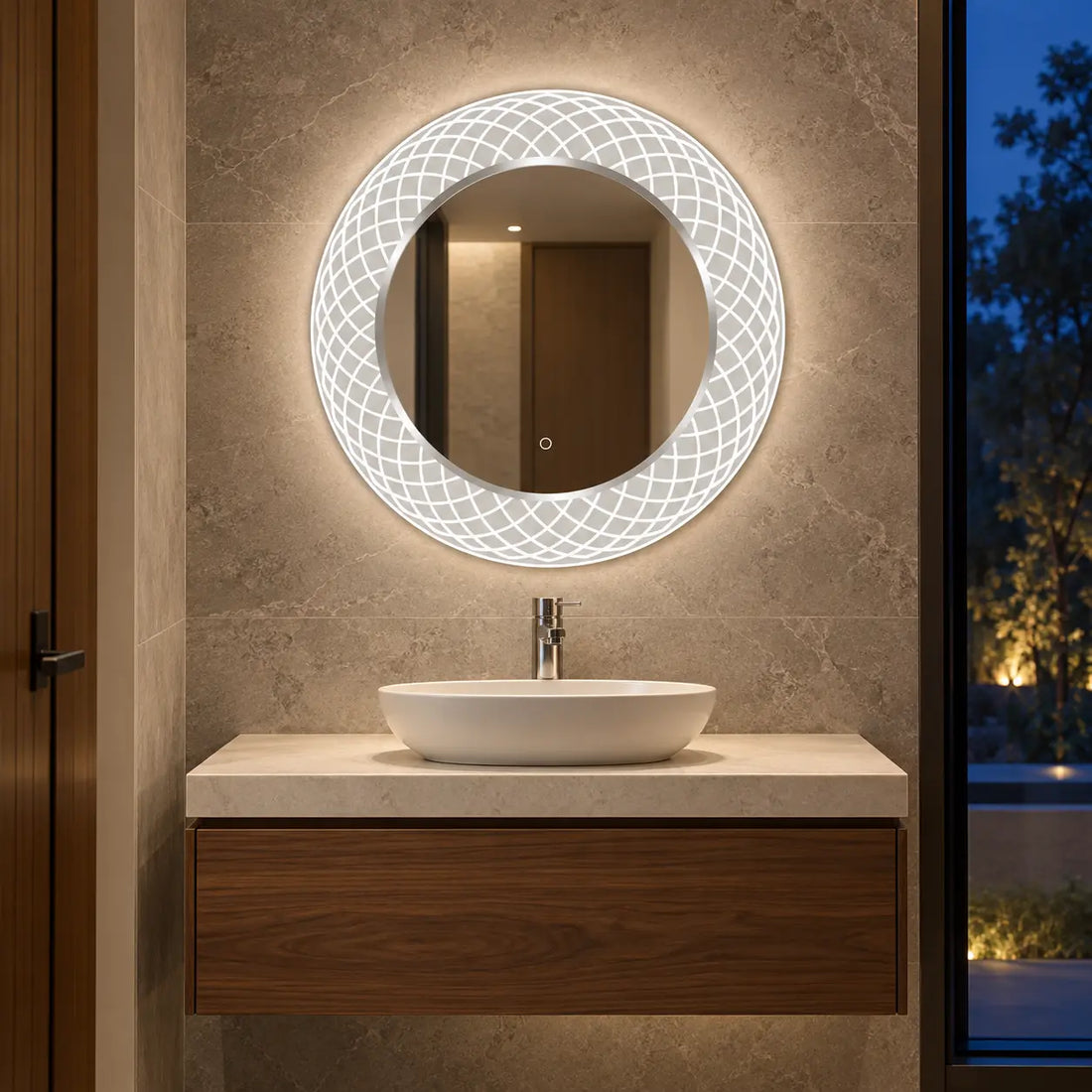 A modern oval Dreamwerks LED-backlit bathroom mirror with a geometric patterned frame, mounted on a textured beige stone wall above a white vessel sink and floating wooden vanity.