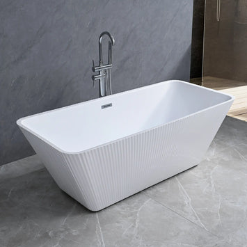 Dreamwerks white fluted freestanding bathtub in a modern bathroom with gray tiles and a shower in the background.
