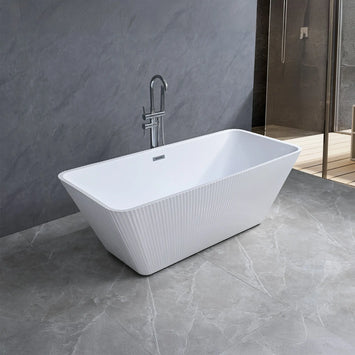 Dreamwerks white fluted freestanding bathtub in a modern bathroom with gray tiles and a shower area.