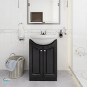 Bathroom with black vanity unit, white sink, and decorative elements.