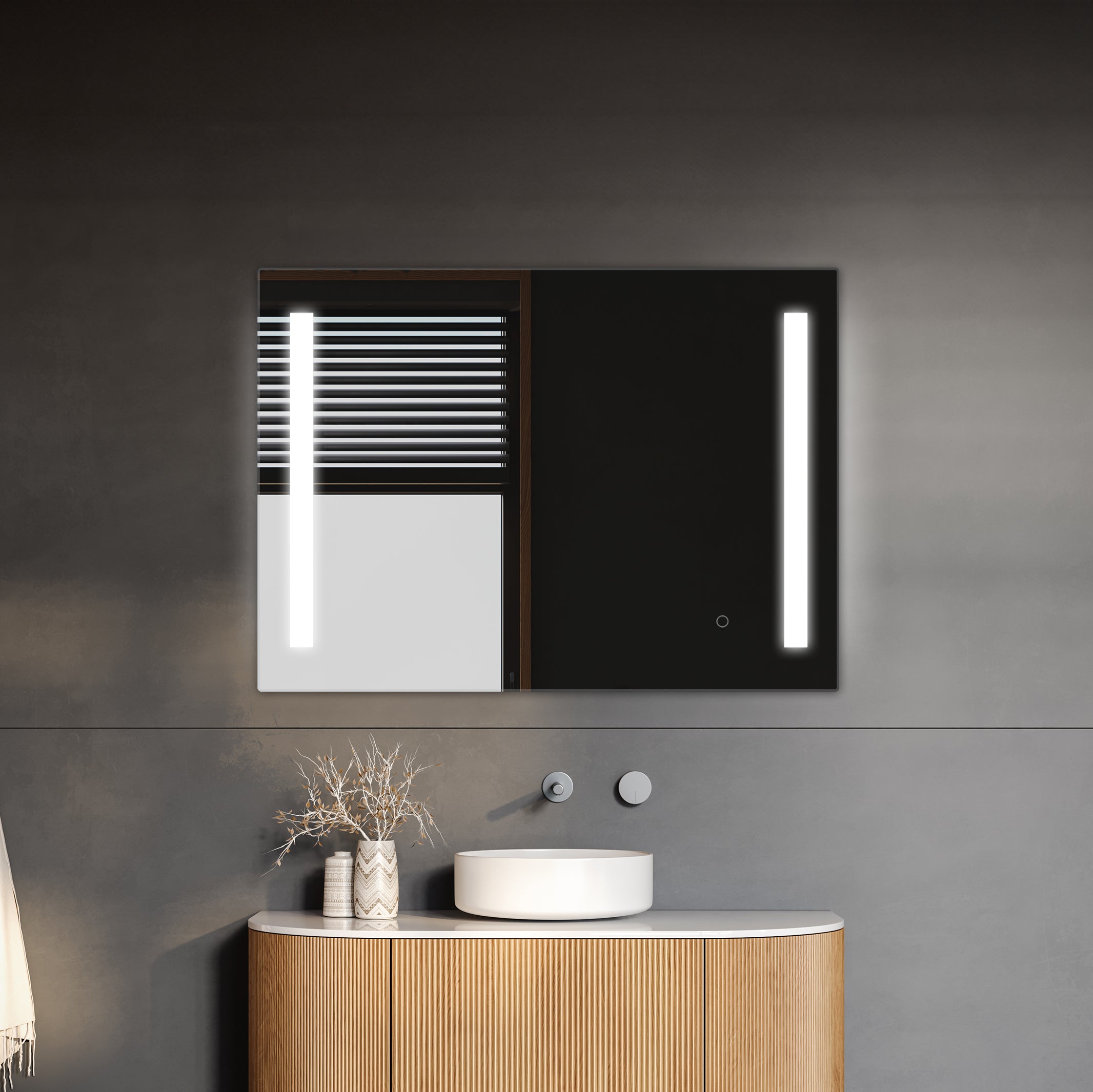 Modern minimalist bathroom vanity with round basin, illuminated by a TREVISO LED mirror with an integrated defogger, and stylish pendant lights against a dark gray wall.