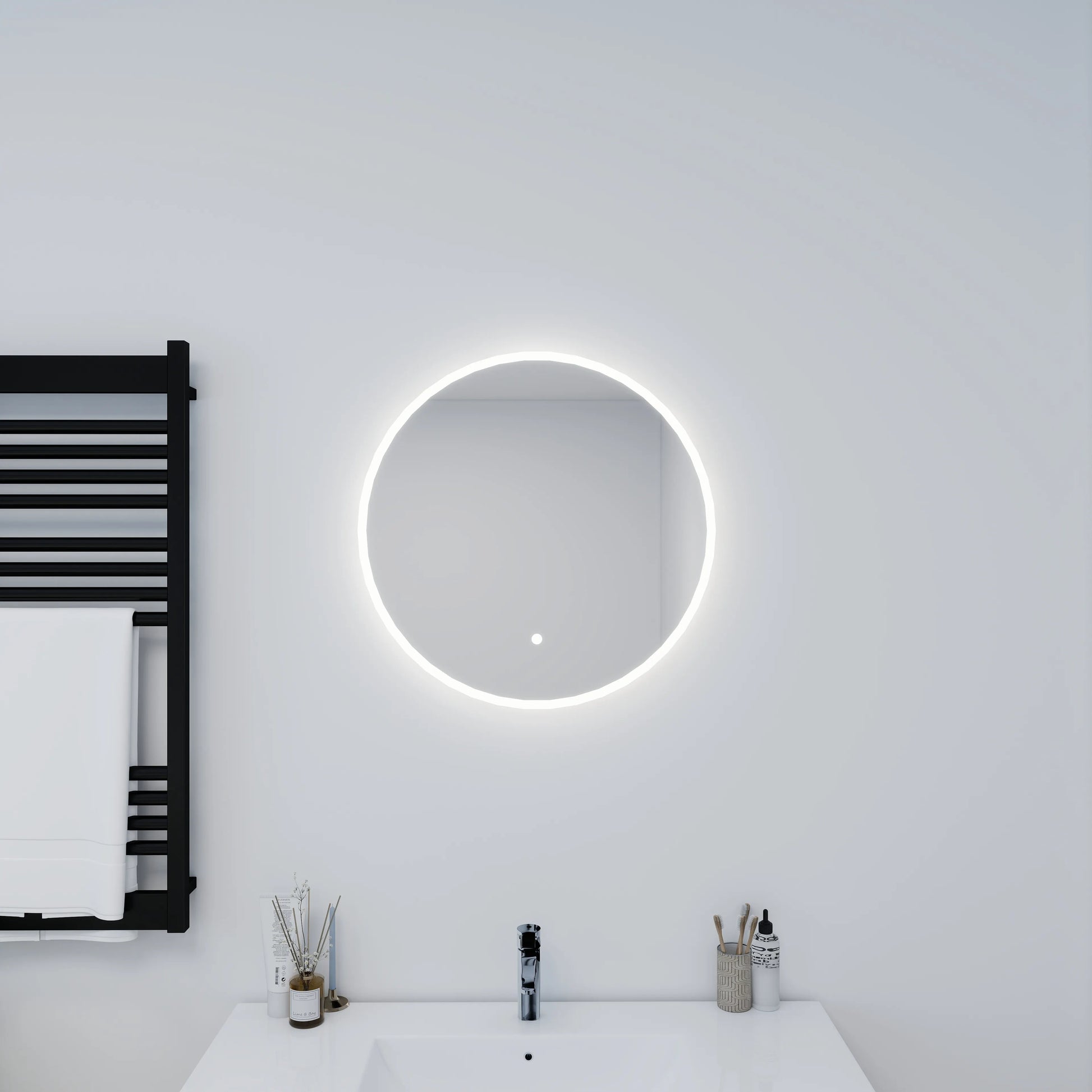 Bathroom with a round illuminated mirror and black towel radiator.