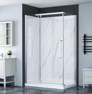 Modern Dreamwerks bathroom with a glass shower enclosure, white vanity, and black towel rack.