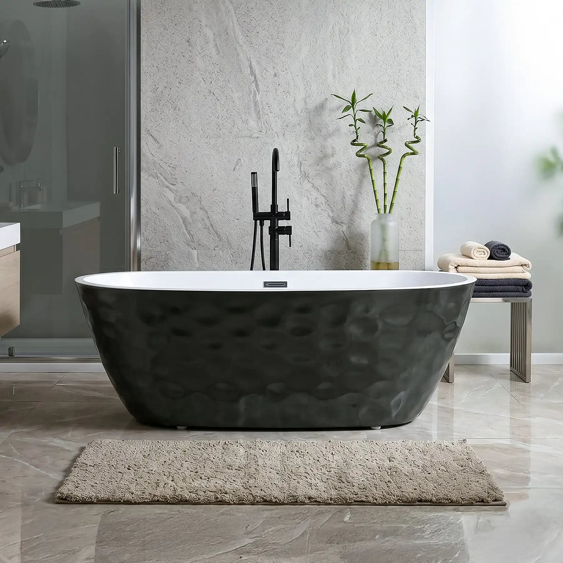 Black freestanding bathtub in a modern bathroom with a gray rug and decorative elements.