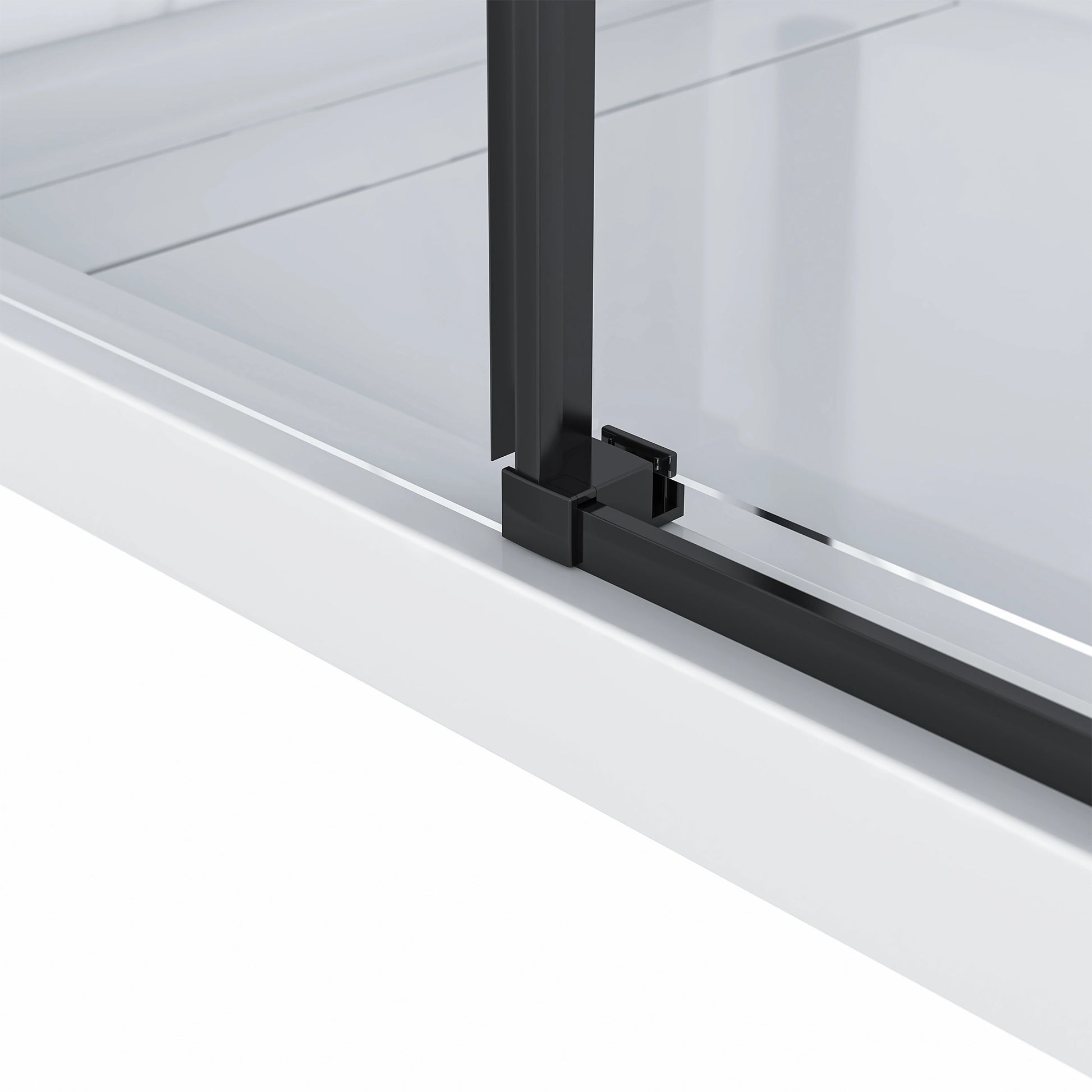 Detailed close-up of the Dreamwerks shower door's bottom guide, showing the matte black vertical frame connecting to the sleek matte black track on the white shower base.