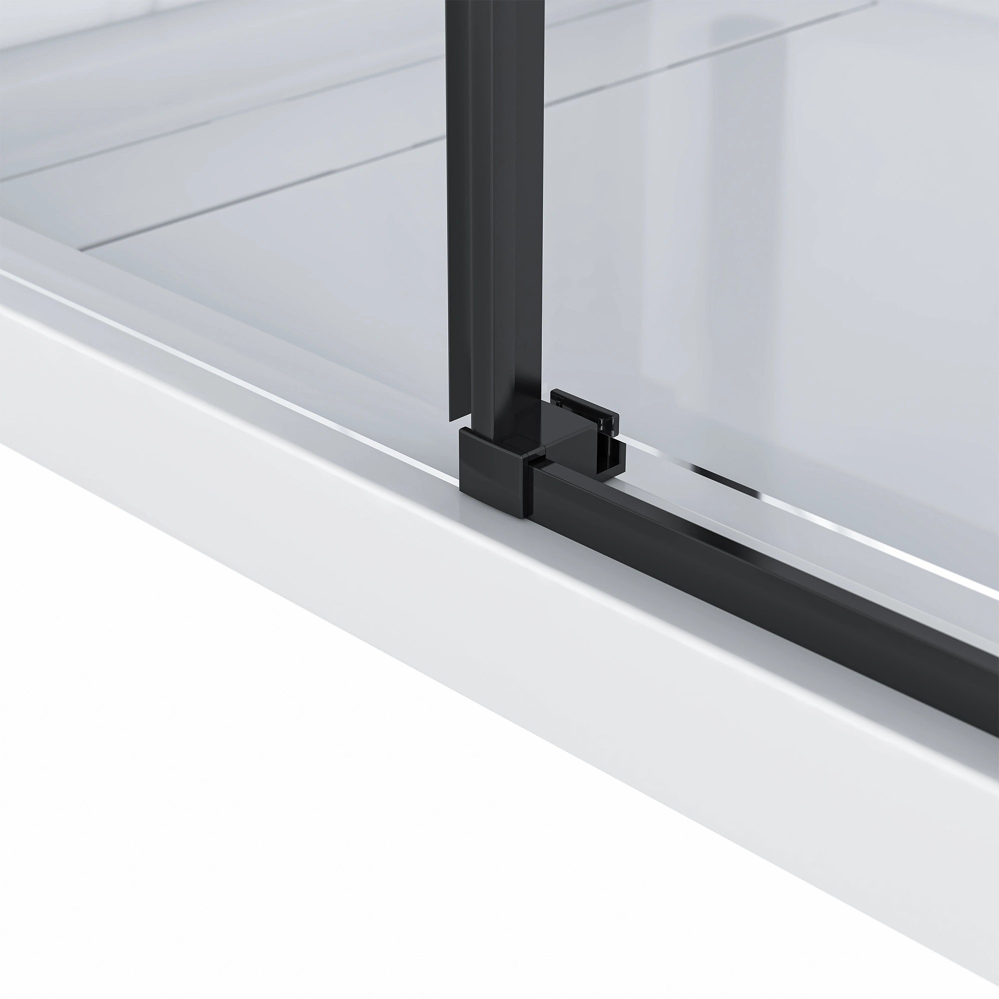 Detailed close-up of the Dreamwerks shower door's bottom guide, showing the matte black vertical frame connecting to the sleek matte black track on the white shower base.