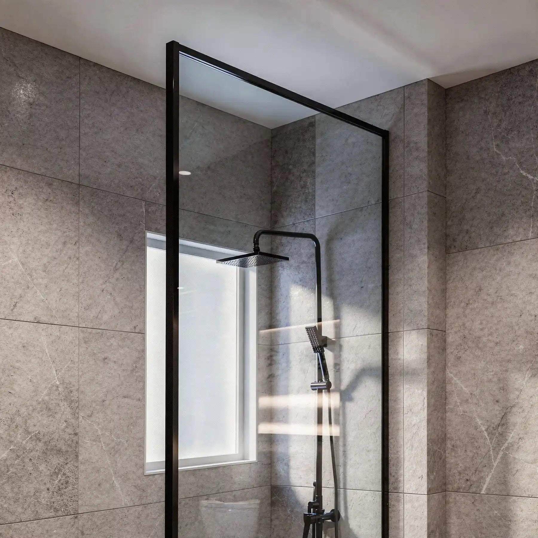 Dreamwerks screen door with black frame in a modern bathroom.