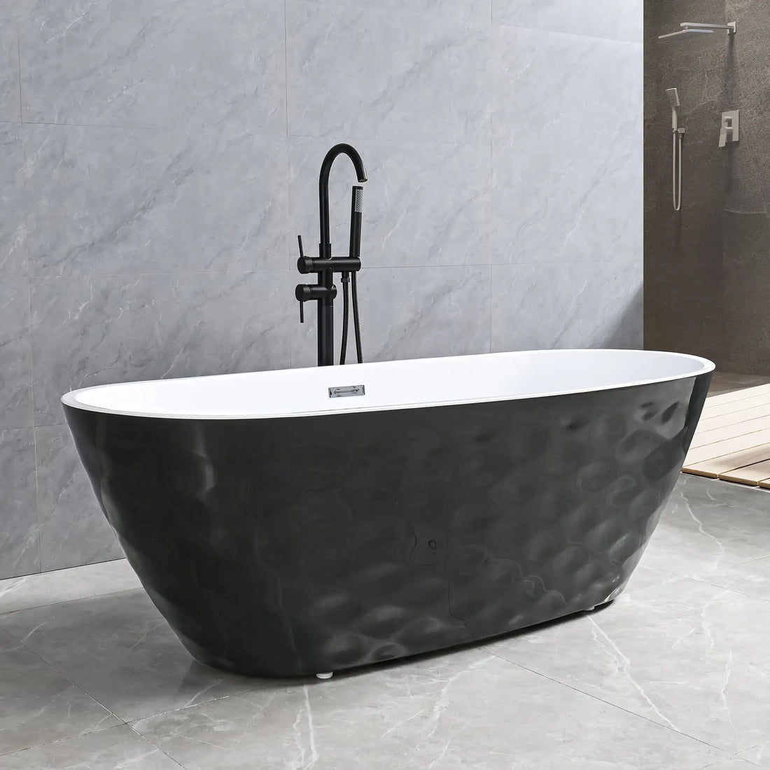 Dreamwerks Corvino matte black freestanding bathtub featuring a distinct, sculpted wavy exterior texture and bright white interior. The tub is complemented by a contemporary matte black floor-mounted faucet in a modern gray tiled bathroom.