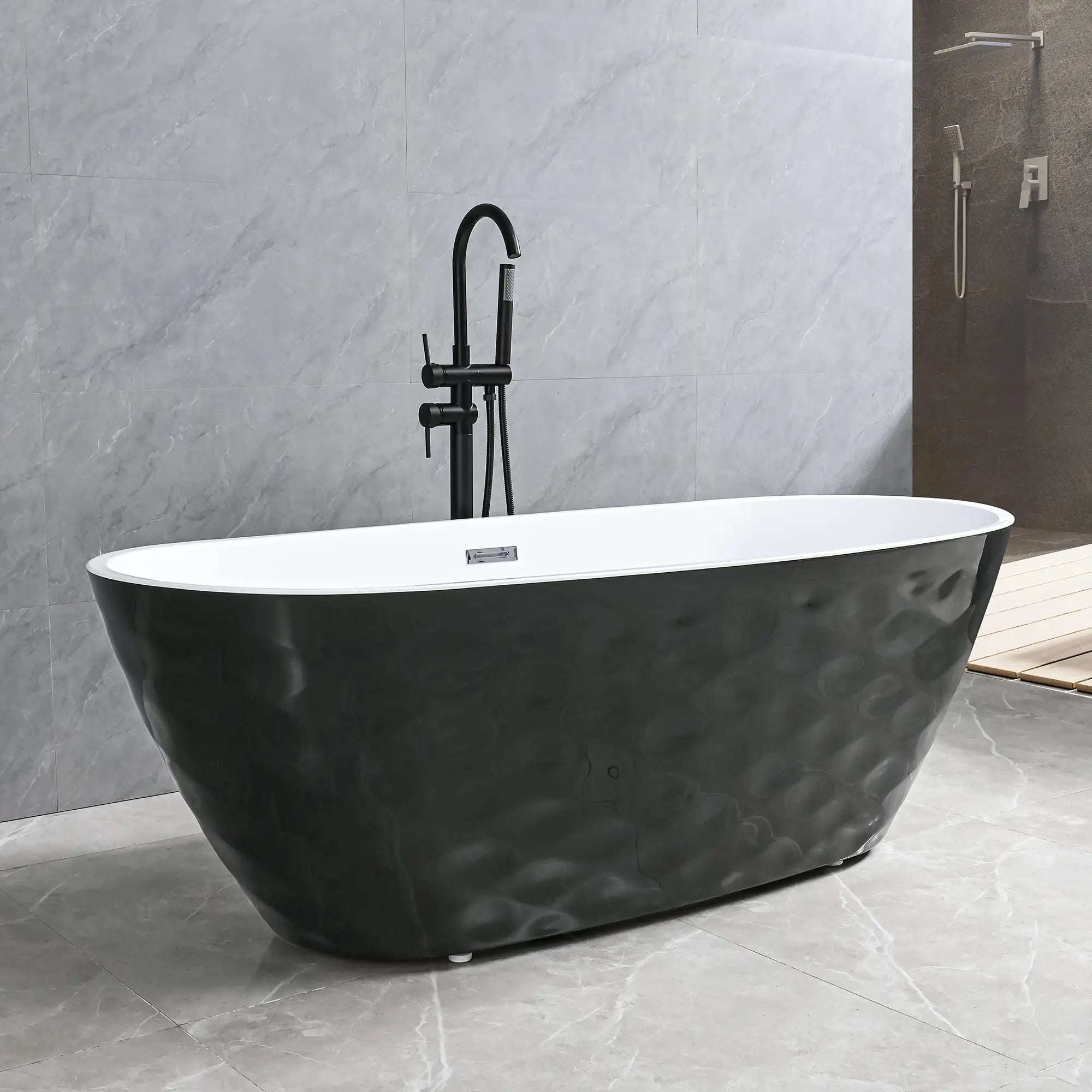 Dreamwerks Corvino matte black freestanding bathtub featuring a distinct, sculpted wavy exterior texture and bright white interior. The tub is complemented by a contemporary matte black floor-mounted faucet in a modern gray tiled bathroom.