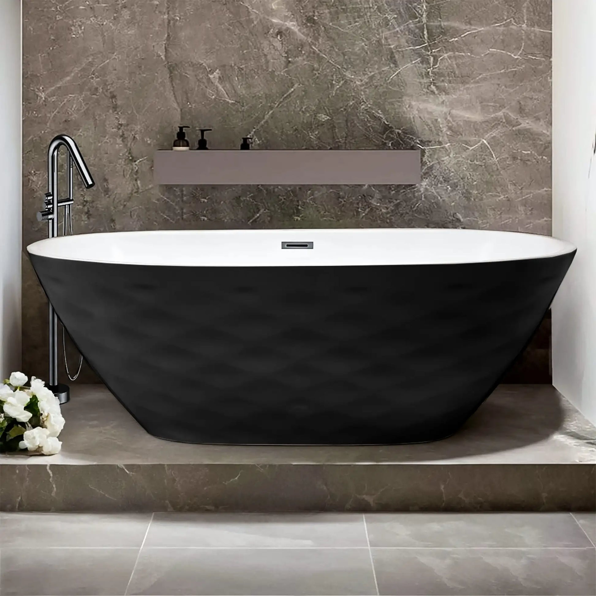 Dreamwerks Corvino matte black freestanding tub with a white interior and a distinctive three-dimensional diamond-quilted pattern on the exterior. The tub is elevated on a tiled platform and has a chrome floor-mounted faucet.