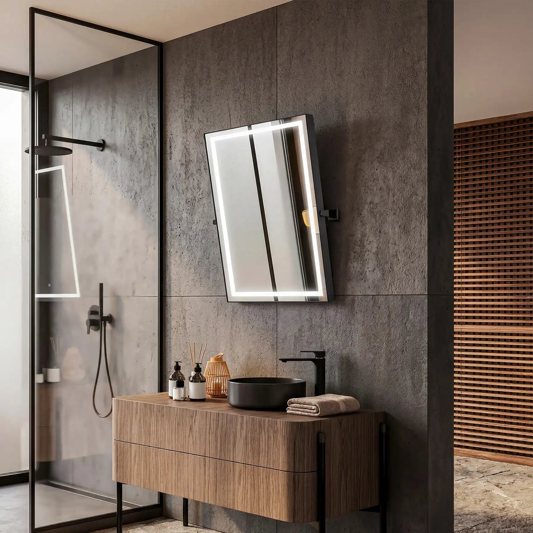 Bathroom interior with wooden vanity, illuminated mirror, and gray tiled walls.