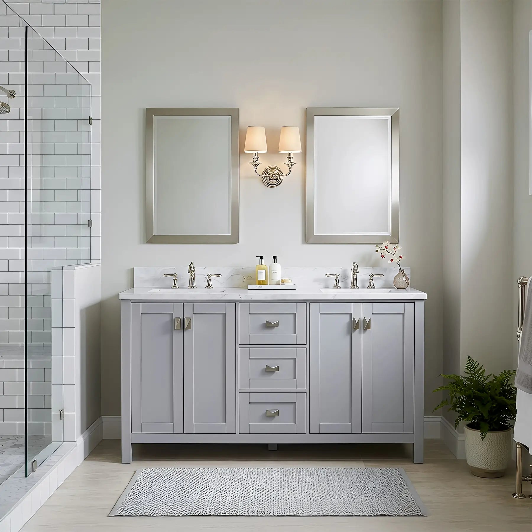 Bathroom with gray vanity, white countertop, and framed mirrors.