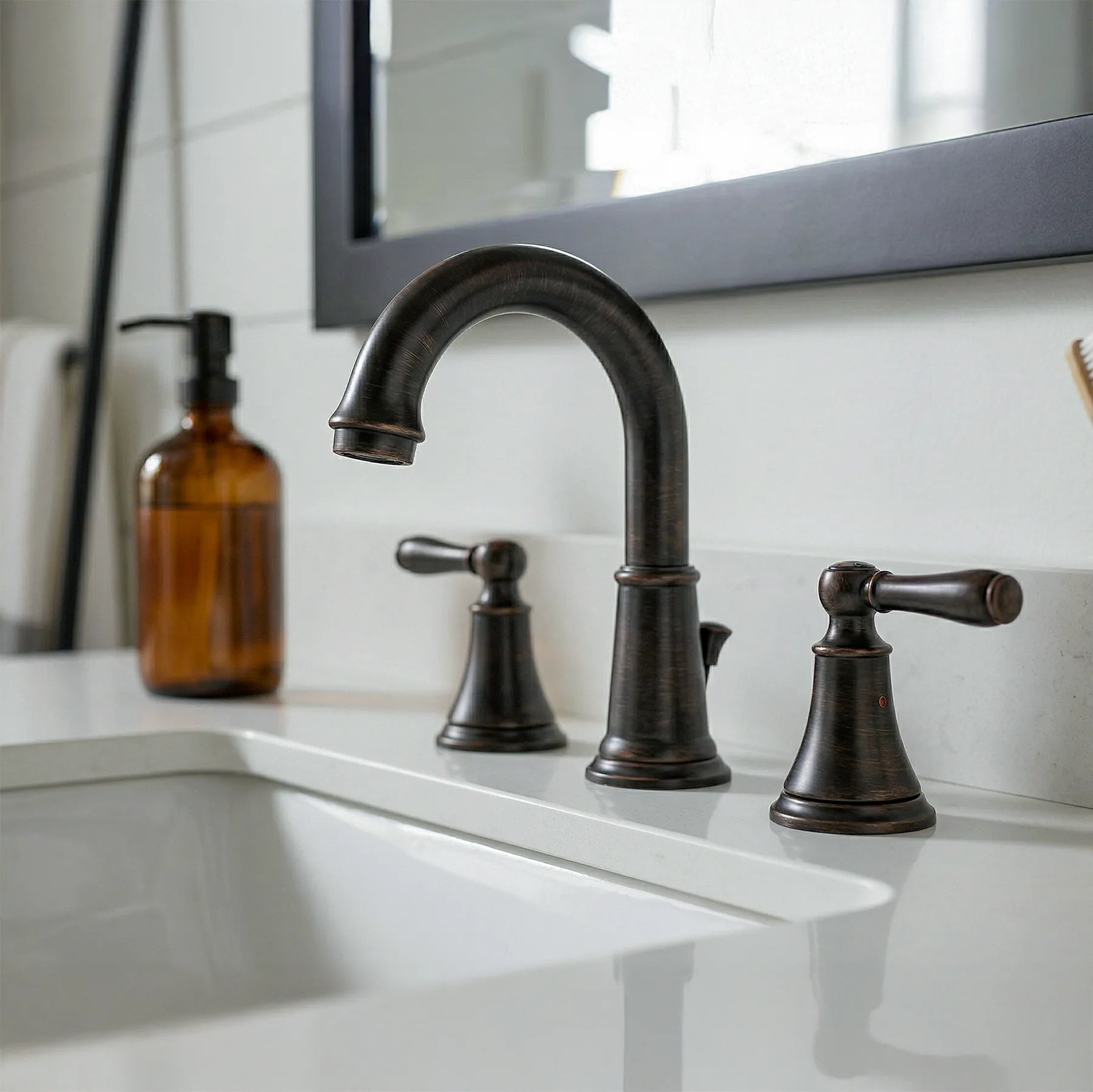 Bronze faucet set on a bathroom sink with a mirror in the background