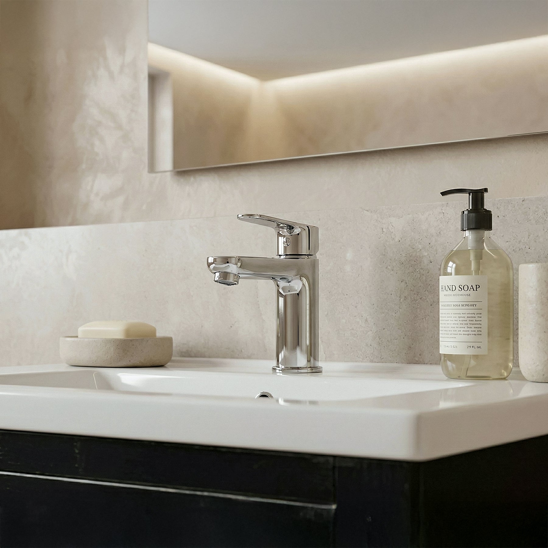 Bathroom sink with soap dispenser and soap bar, modern faucet, and neutral wall.