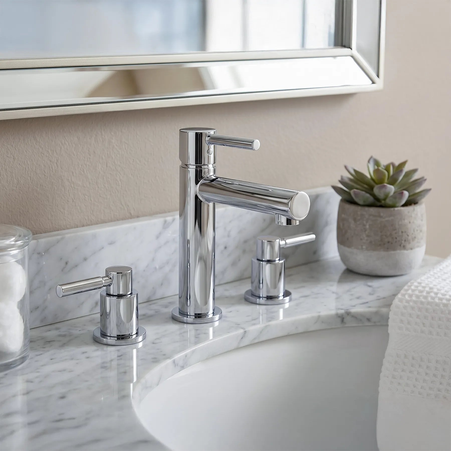 Bathroom sink with chrome faucet and marble countertop