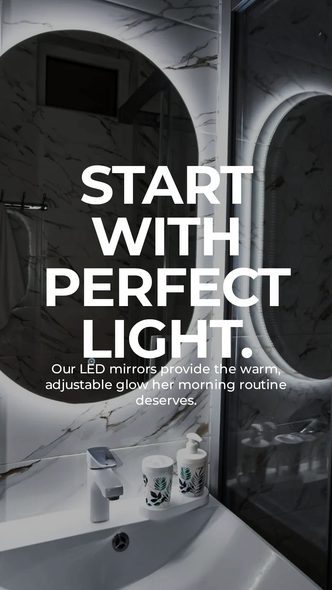 Dreamwerks oval frameless LED bathroom mirror with adjustable warm backlighting, anti-fog technology, and touch-sensor control mounted on premium white marble wall tiles.