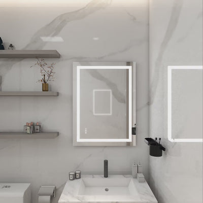 Modern Dreamwerks LED bathroom mirror with illuminated frame and touch controls, mounted above a white vanity in a marble wall bathroom.